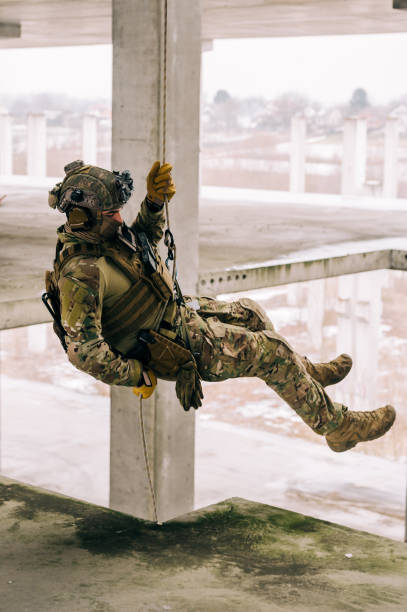 istock Rappeling on the rope in the abandoned building, military training 1366931051
