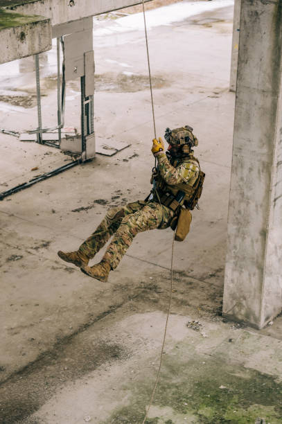 istock Rappeling on the rope in the abandoned building, military training 1366931054