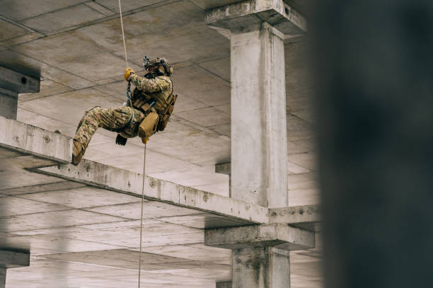 istock Rappeling on the rope in the abandoned building, military training 1366931056