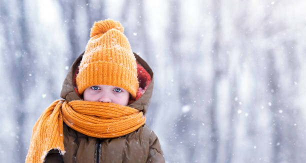 istock a boy in a bright yellow hat and scarf 1366931255