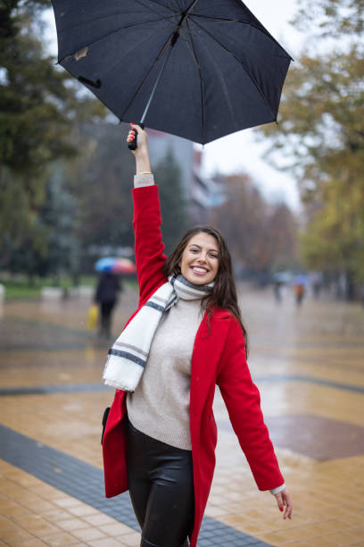 istock Young woman enjoying rainy weather 1366932206