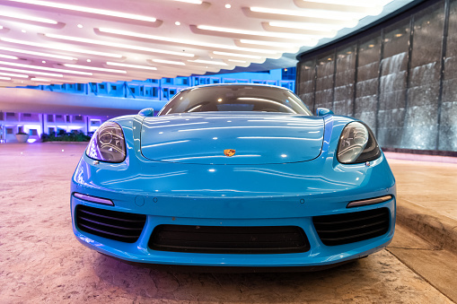 Palm Beach, Florida USA - March 22, 2021: blue Porsche 718 Cayman luxury sport car in palm beach, united states of america. closeup front view. Porsche is luxury car brand