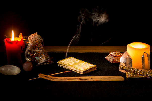 istock Still life with tarot cards, candles, incense and other objects on a black card table. 1366933649