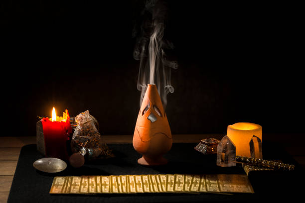 istock Still life with tarot cards, candles, incense and other objects on a black card table. 1366933664