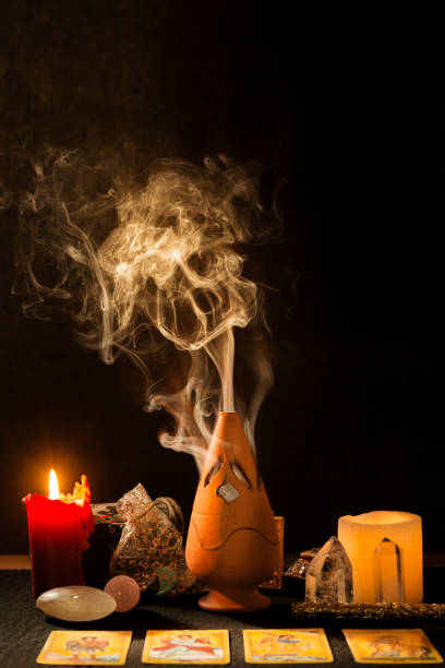 istock Still life with tarot cards, candles, incense and other objects on a black card table. 1366933681