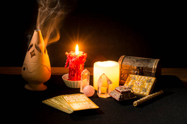 istock Still life with tarot cards, candles, incense and other objects on a black card table. 1366933704