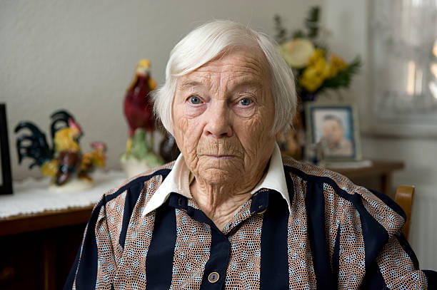 Very old female senior is alone at home Confused old woman with many wrinkles in the face sits alone at home over 100 stock pictures, royalty-free photos & images
