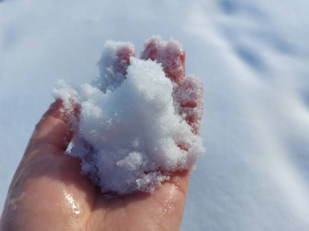 istock Woman holding snow ball with bare hand 1366934811