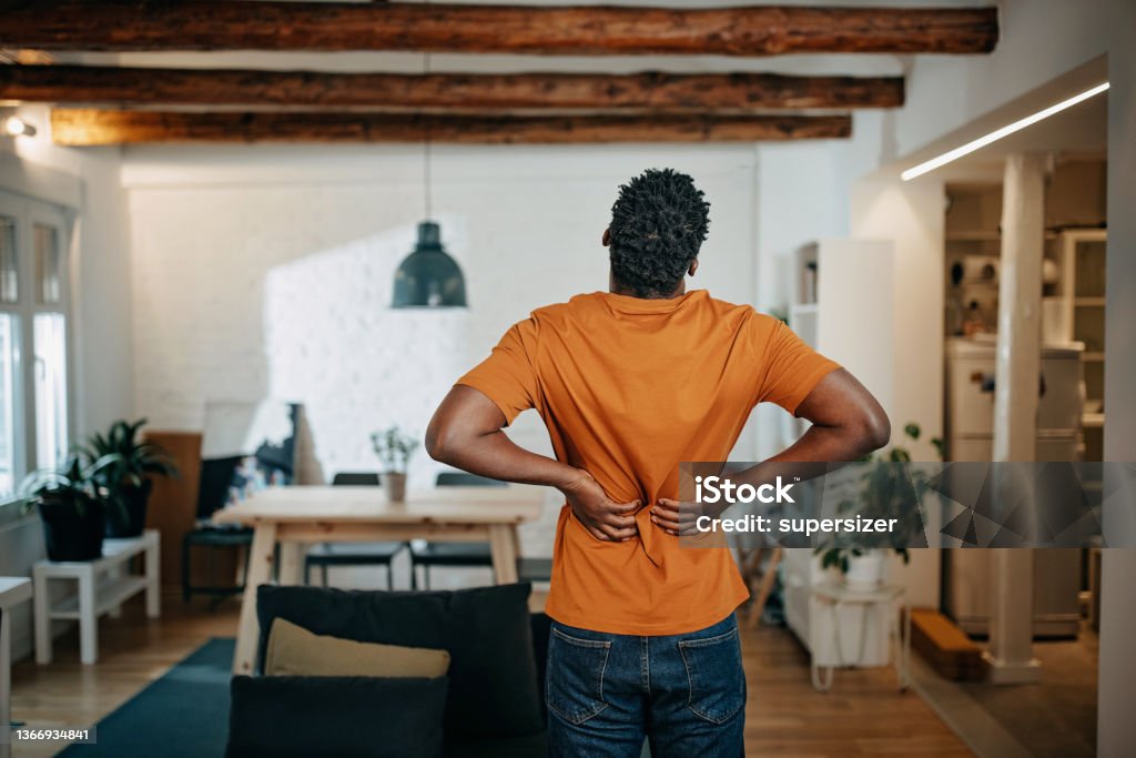 Young African-American man having pain Backache Stock Photo