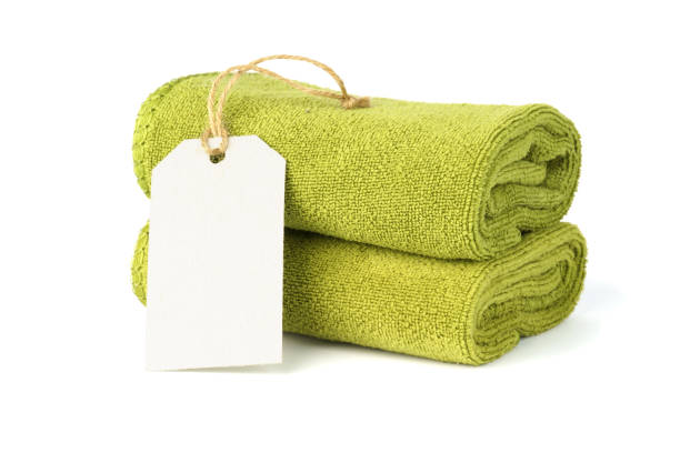 two towels with blank card for price or text isolated on white background