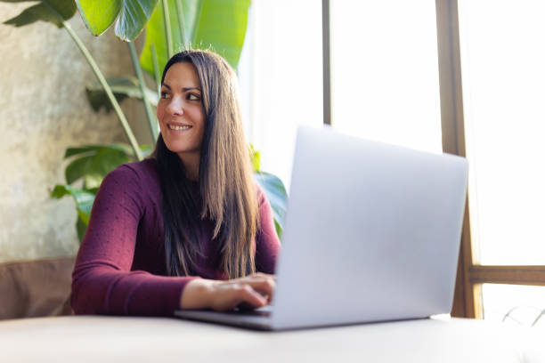 istock Woman using laptop at home 1366937345