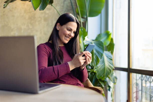 istock Woman using laptop at home 1366937360