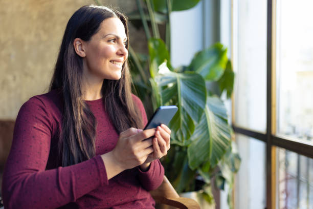istock Woman checking bank account using mobile app 1366937371