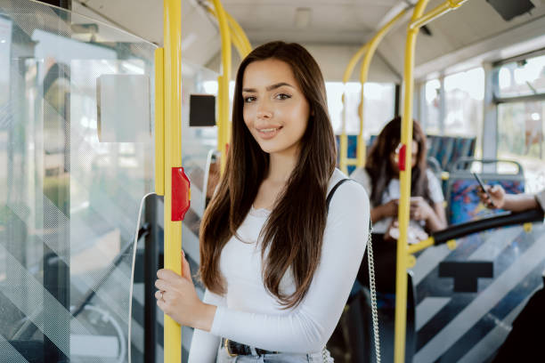 istock An attractive student spends her morning on the bus going to university, a young beautiful woman uses public transportation stands at the door waiting for the vehicle to stop at the bus stop 1366938194