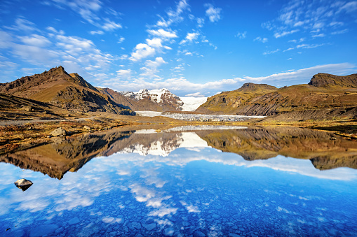 Svinafellsjokull, an outlet glacier of Vatnajokull, the largest ice cap in Europe. Mirror reflection in the glacial lagoon, Iceland