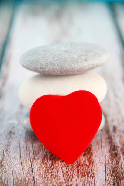 istock red heart on gray stones 1366939190