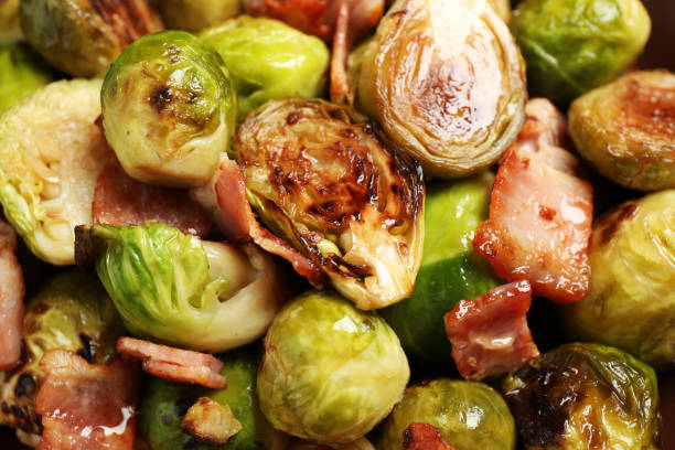 istock Delicious fried Brussels sprouts with bacon as background, closeup 1366939384