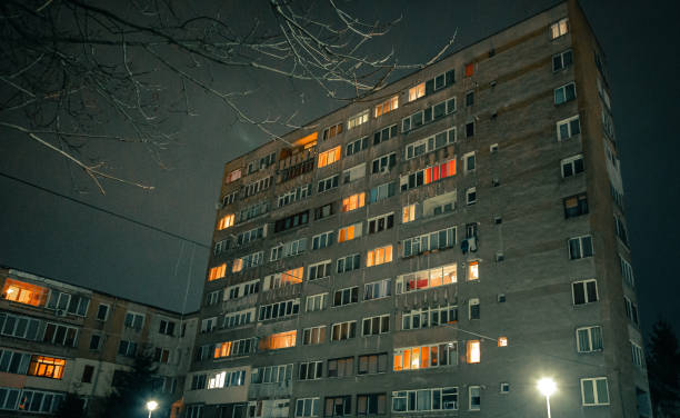 istock Exterior architecture of apartment block with illuminated windows at night 1366939610