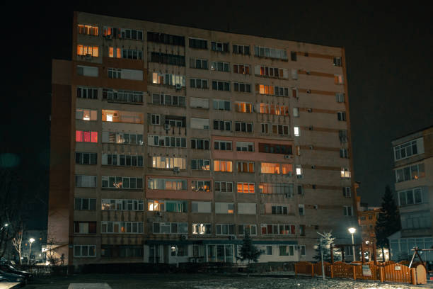 istock Exterior architecture of apartment block with illuminated windows at night 1366939613