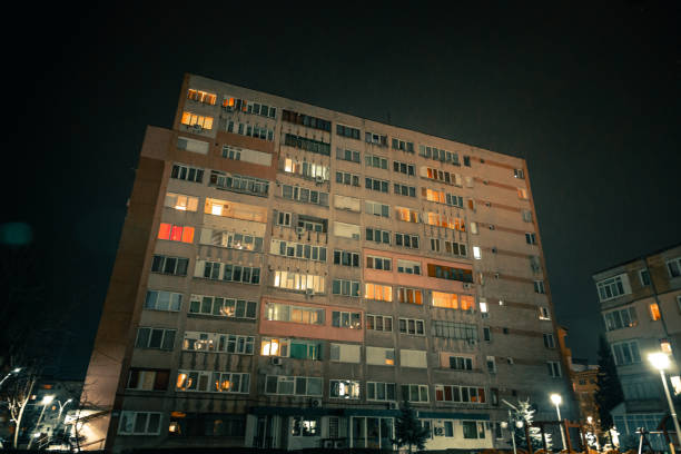 istock Exterior architecture of apartment block with illuminated windows at night 1366939637