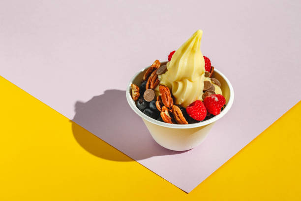 istock Frozen yogurt with raspberries, blueberries, chocolate drops and pecans. Hard light, deep shadow 1366939645