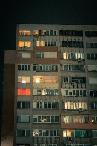 istock Exterior architecture of apartment block with illuminated windows at night 1366939648