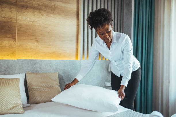 istock Maid working making the bed at a hotel. 1366940523