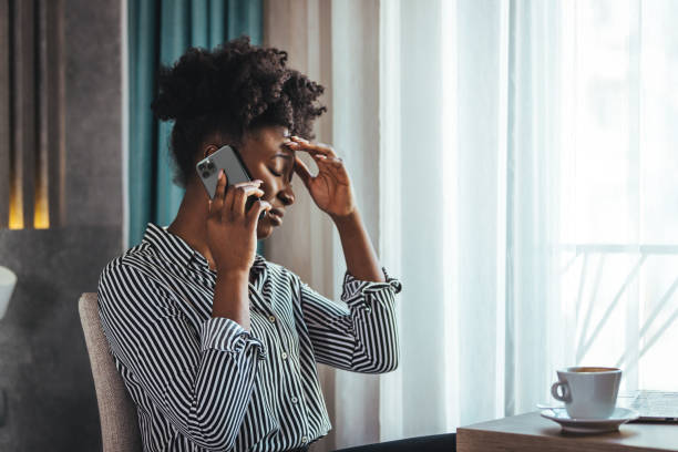 istock Outraged attractive employee talking on the phone 1366940645