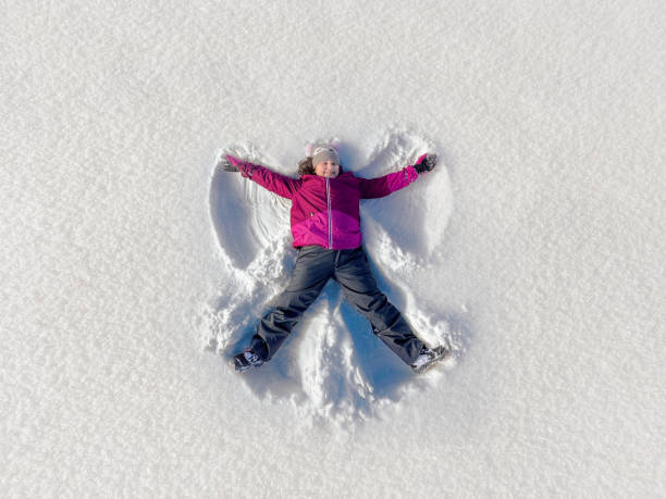 istock Child making angels on a snow field 1366941513