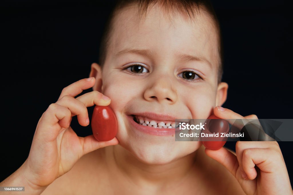 Boy with tomato Little boy Boys Stock Photo