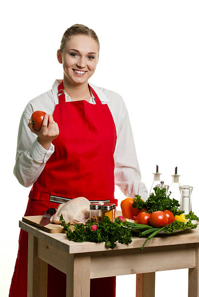 istock Young woman smiles holding tomato 136694162