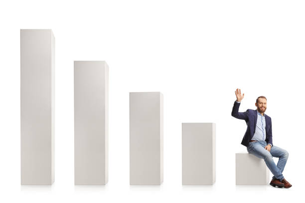 istock Young professional man in suit and jeans sitting on a graph chart and waving 1366941780