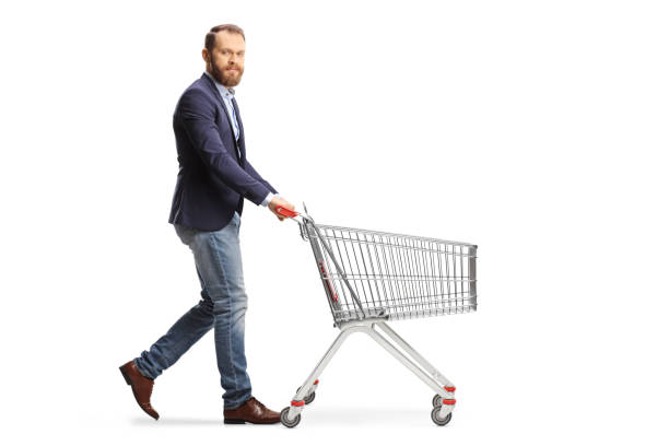 istock Bearded guy walking and pushing and empty shopping cart 1366941922