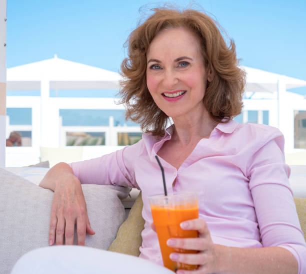 istock Woman relaxing at the beach 1366942133