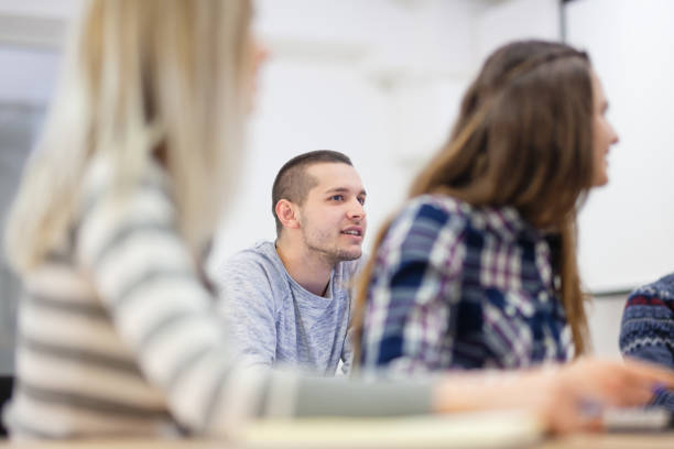 istock Young student in modern classroom listening to lecture. 1366942310