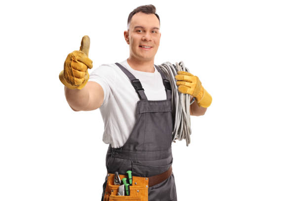 istock Electrician carrying cables on his shoulder and gesturing thumbs up 1366942343