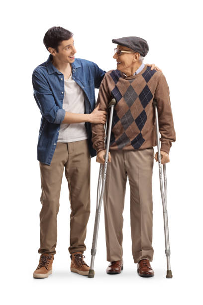 älterer mann mit krücken und ein junger mann, der steht und sich ansieht - full grown stock-fotos und bilder