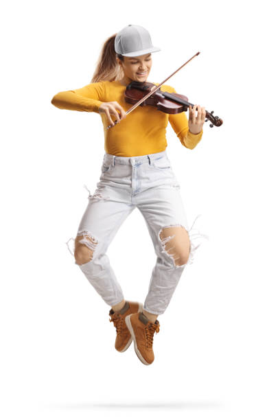 istock Trendy young female violinist playing a violin and dancing 1366943493