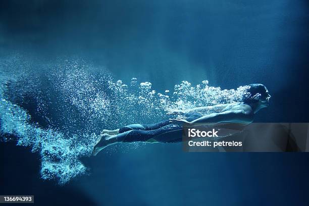 Female Swimmer Underwater Flowing On Blue Background Stock Photo - Download Image Now