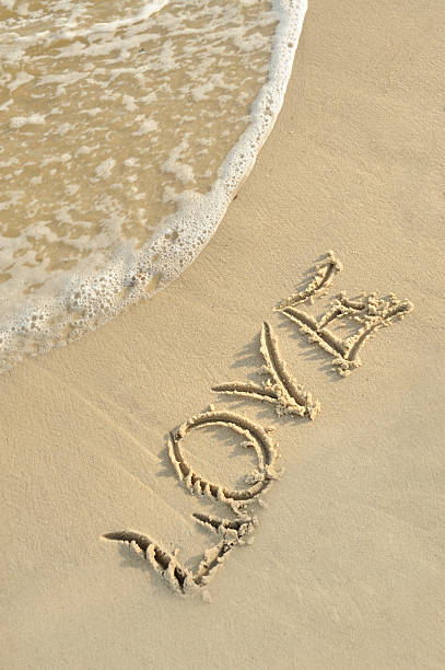 Inscription &quot;love&quot; on sand stock photo