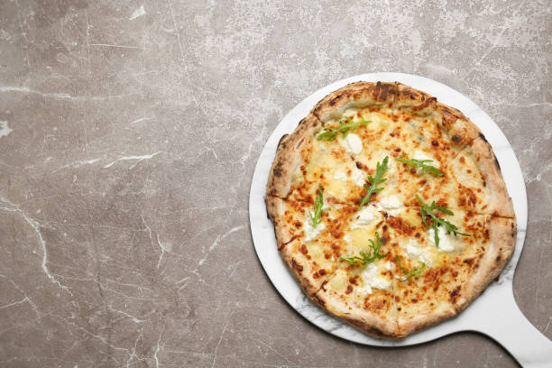 istock Tasty cheese pizza on grey marble table, top view. Space for text 1366944260