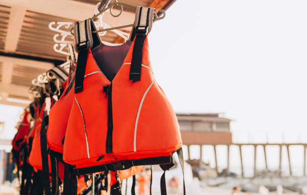 istock Life jacket on rail for costumer, Red Life jacket with black belts, Personal flotation device. Life jacket ready to be used by tourist going on a boat trip. 1366945190