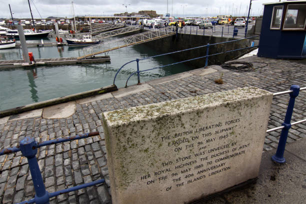 The stone commemorating british forces landing Guernsey on the 9th may 1945. UK UK - Guernsey - The stone commemorating the 40th anniversary of the british liberationg forces landing Guernsey on the 9th may 1945 guernsey city stock pictures, royalty-free photos & images
