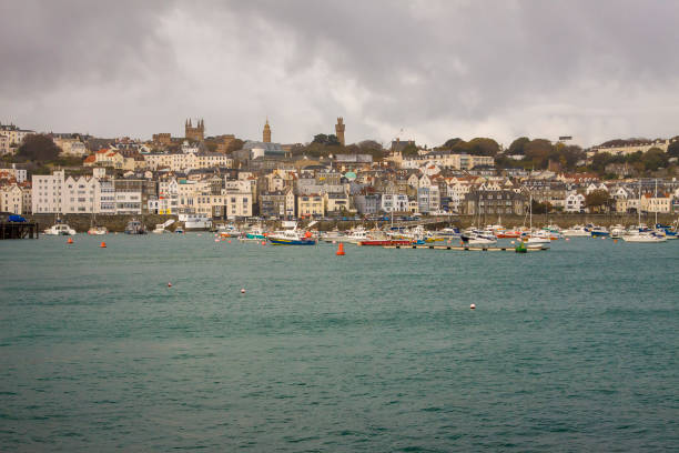 Panorama of coastal town St Peter Port in fall. Guernsey, UK UK - Guernsey - The fall panorama of coastal town St Peter Port and its marina guernsey city stock pictures, royalty-free photos & images