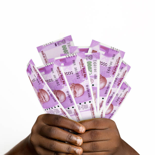 istock Black hands holding 2000 Indian rupee notes. closeup of Hands holding Indian currency notes 1366945404