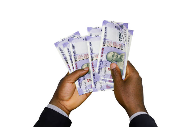 istock Black Hands in suit holding 3D rendered Indian Rupee notes 1366945412