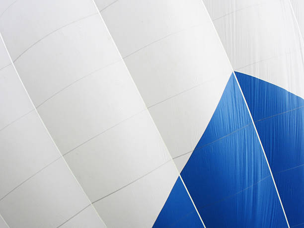 Closeup of inflated blue and white hot air balloon.
