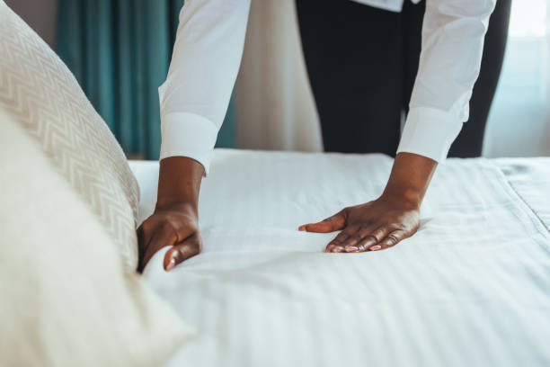 istock Maid working making the bed at a hotel. 1366947045