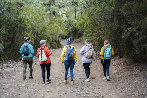 istock Multiracial women having fun during trekking day in mountain forest 1366947292