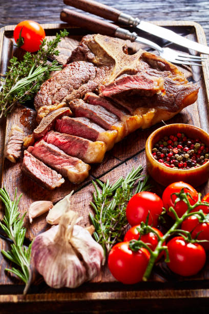 istock fried sliced porterhouse steak on a wooden board 1366948010